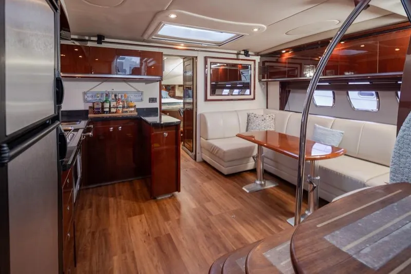 Slide: The Image of Luxurious interior of 2010 Sea Ray 500 Sundancer yacht with kitchen and seating area. - 17