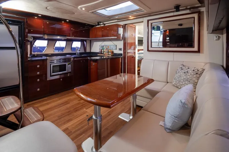 Slide: The Image of Luxurious interior of 2010 Sea Ray 500 Sundancer yacht with modern kitchen and seating area. - 18