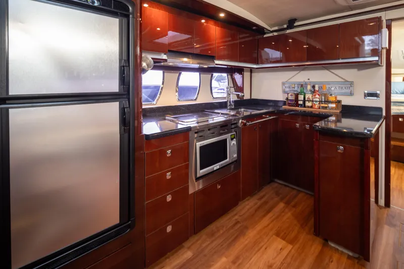 Slide: The Image of Luxurious kitchen interior of 2010 Sea Ray 500 Sundancer yacht with modern appliances. - 19