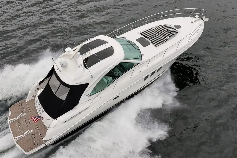 Slide: The Image of 2010 Sea Ray 500 Sundancer yacht cruising on open water, aerial view. - 2