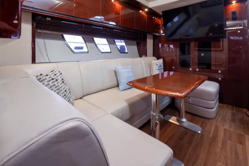 Slide: The Image of Luxurious interior of 2010 Sea Ray 500 Sundancer yacht with plush seating and elegant wood finishes. - 21