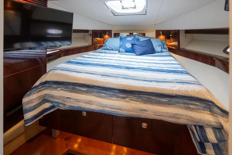 Slide: The Image of Luxurious cabin interior of 2010 Sea Ray 500 Sundancer yacht with cozy bedding and TV. - 23