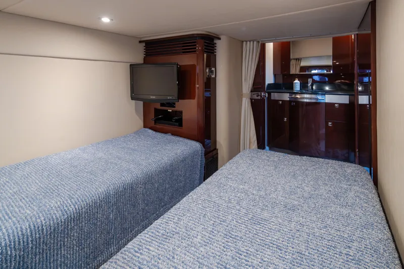 Slide: The Image of Interior cabin of 2010 Sea Ray 500 Sundancer with twin beds and TV. - 27