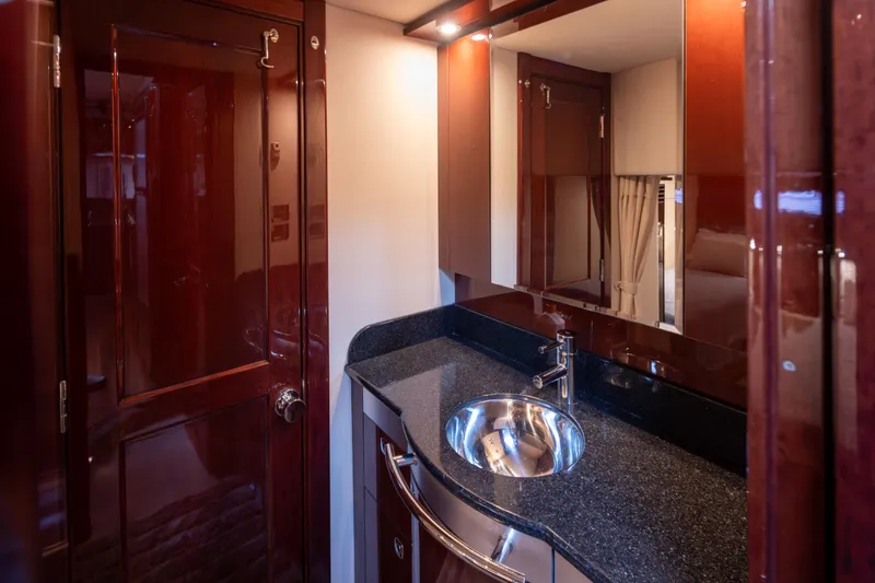 Slide: The Image of Luxurious bathroom interior of 2010 Sea Ray 500 Sundancer yacht with sleek wood finish. - 28