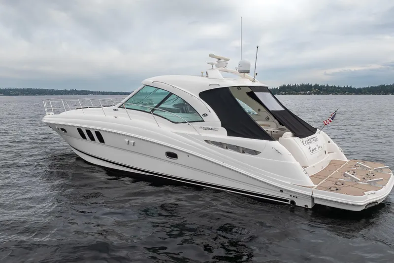 Slide: The Image of 2010 Sea Ray 500 Sundancer yacht on calm waters under cloudy skies. - 3