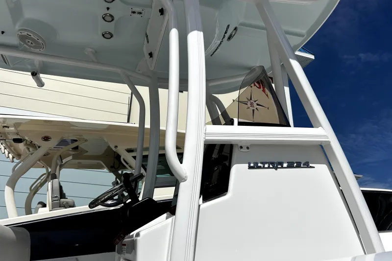 Slide: The Image of 2017 Sea Hunt Ultra 232 boat with T-top and steering console, viewed from the side. - 10