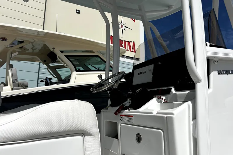 Slide: The Image of 2017 Sea Hunt Ultra 232 boat interior with steering wheel and Simrad display. - 11
