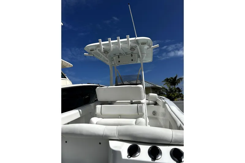 Slide: The Image of 2017 Sea Hunt Ultra 232 boat interior with T-top under clear blue sky. - 14