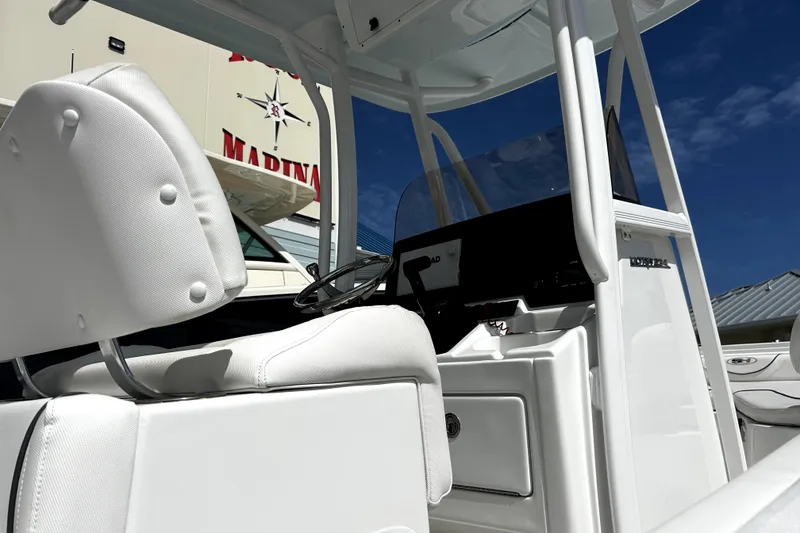 Slide: The Image of 2017 Sea Hunt Ultra 232 boat interior with white seating and steering console. - 15