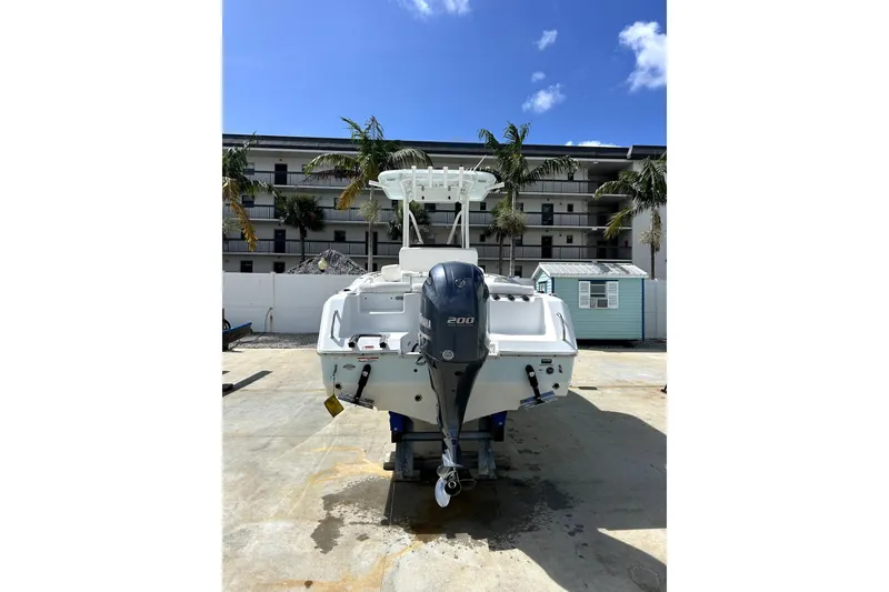 Slide: The Image of 2017 Sea Hunt Ultra 232 boat with Yamaha 200 engine, parked outdoors. - 3