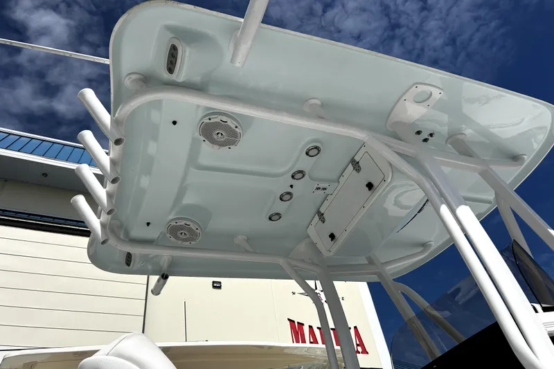 Slide: The Image of 2017 Sea Hunt Ultra 232 boat's T-top with rod holders and speakers under a blue sky. - 8