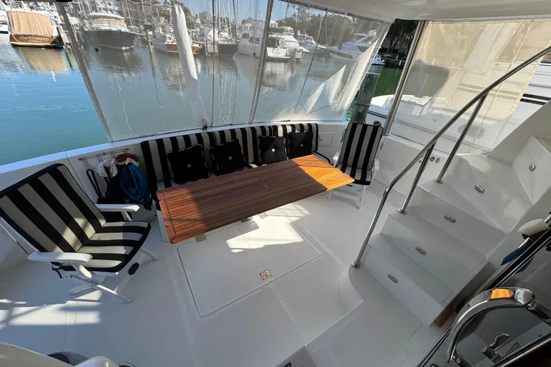 Slide: The Image of 2003 Altima 55 Pilothouse yacht interior with striped seating and wooden table. - 20