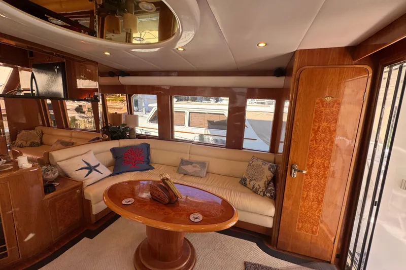 Slide: The Image of Luxurious interior of 2003 Altima 55 Pilothouse yacht with elegant wood finishes and plush seating. - 22