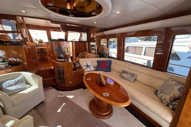 Slide: The Image of Luxurious interior of 2003 Altima 55 Pilothouse yacht with elegant seating and wooden accents. - 24