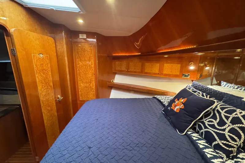 Slide: The Image of Luxurious 2003 Altima 55 Pilothouse cabin with elegant wood paneling and cozy bedding. - 34