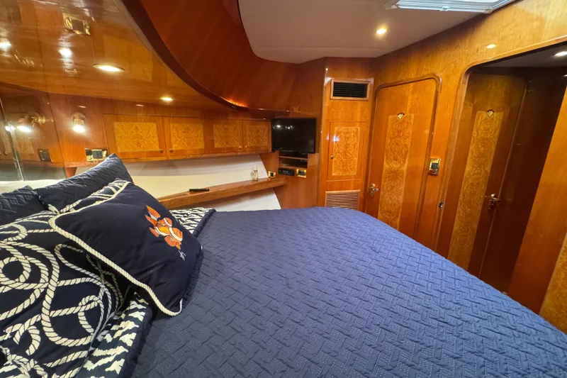 Slide: The Image of Luxurious 2003 Altima 55 Pilothouse cabin with elegant wood paneling and cozy bedding. - 35