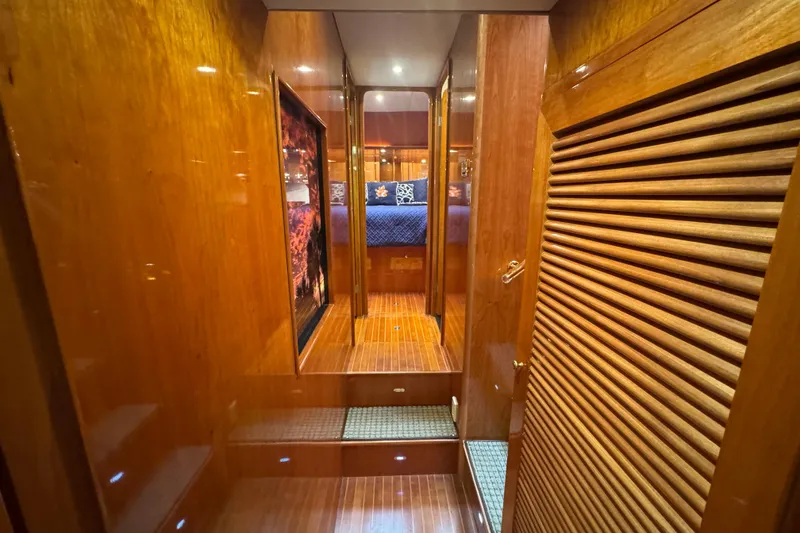 Slide: The Image of Luxurious wooden interior of 2003 Altima 55 Pilothouse yacht, featuring a cozy bedroom. - 46