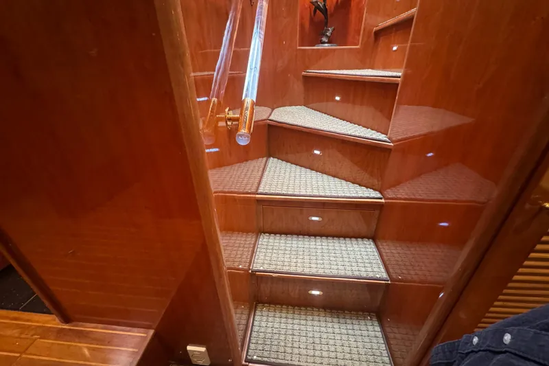 Slide: The Image of Wooden staircase with carpeted steps and handrail on a 2003 Altima 55 Pilothouse yacht. - 47