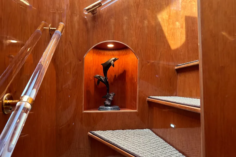 Slide: The Image of Staircase in 2003 Altima 55 Pilothouse with dolphin sculpture and wooden finish. - 51