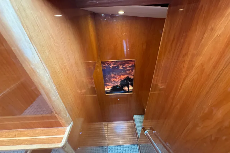 Slide: The Image of Wooden staircase inside 2003 Altima 55 Pilothouse yacht with sunset view. - 52