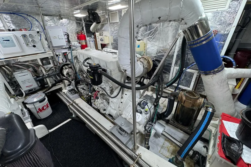 Slide: The Image of Engine room of a 2003 Altima 55 Pilothouse yacht, showcasing machinery and equipment. - 55