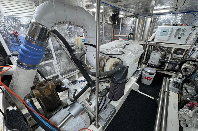 Slide: The Image of Engine room of 2003 Altima 55 Pilothouse yacht, showcasing mechanical components and equipment. - 56