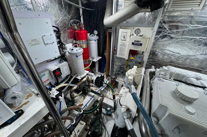 Slide: The Image of Engine room of 2003 Altima 55 Pilothouse with mechanical equipment and fire extinguisher. - 60