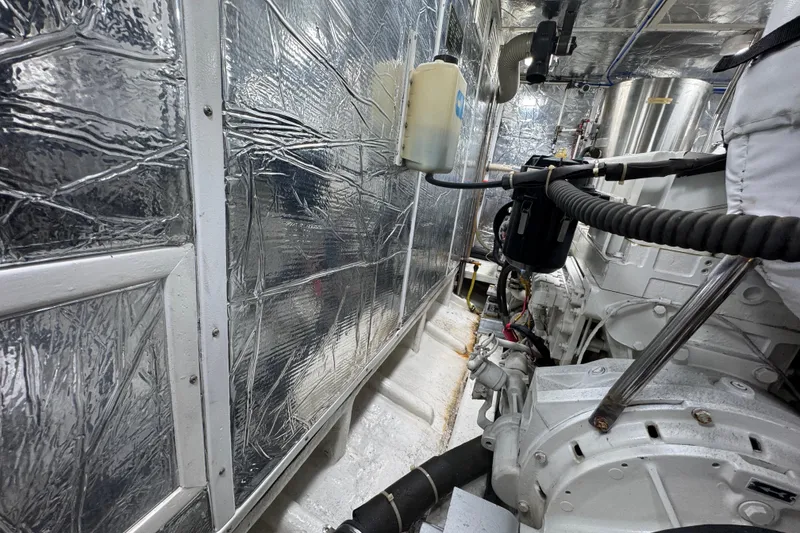 Slide: The Image of Engine room of 2003 Altima 55 Pilothouse with metallic insulation and machinery. - 62