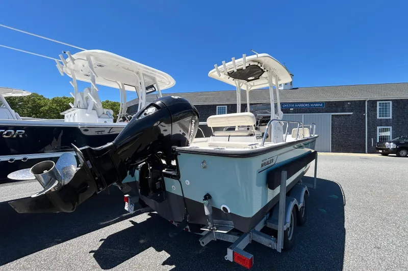 Slide: The Image of 2021 Boston Whaler 210 Montauk boat on trailer at marina under clear blue sky. - 1
