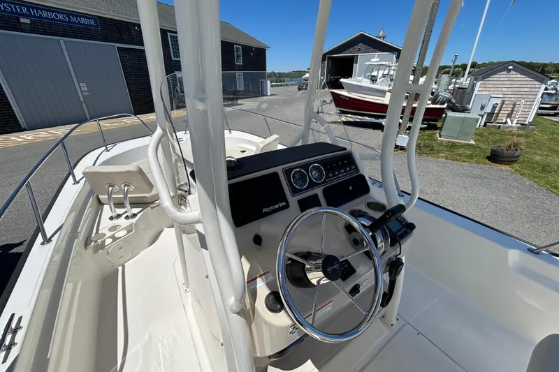 Slide: The Image of 2021 Boston Whaler 210 Montauk boat interior with steering console at marina. - 11
