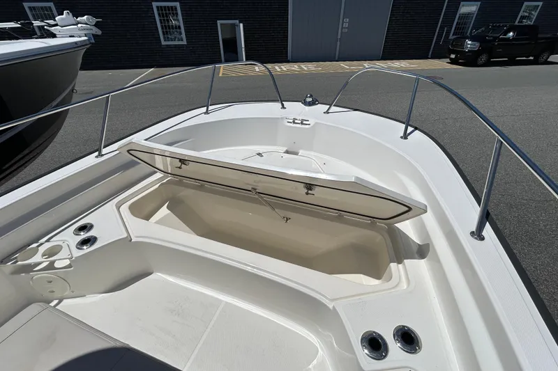 Slide: The Image of 2021 Boston Whaler 210 Montauk boat with open storage compartment on deck. - 22