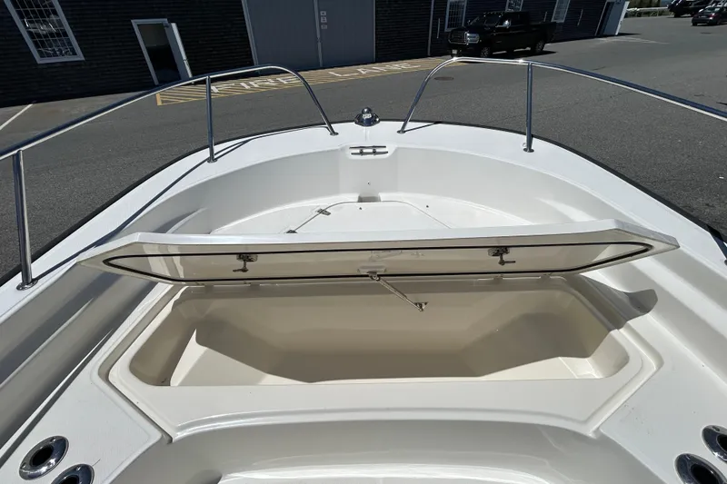 Slide: The Image of 2021 Boston Whaler 210 Montauk boat with open storage compartment on deck. - 23
