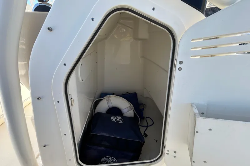 Slide: The Image of Storage compartment of a 2021 Boston Whaler 210 Montauk with life jackets and a life ring. - 25