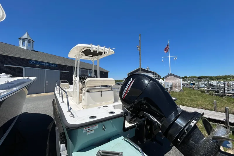 Slide: The Image of 2021 Boston Whaler 210 Montauk boat with Mercury engine at marina under clear blue sky. - 4