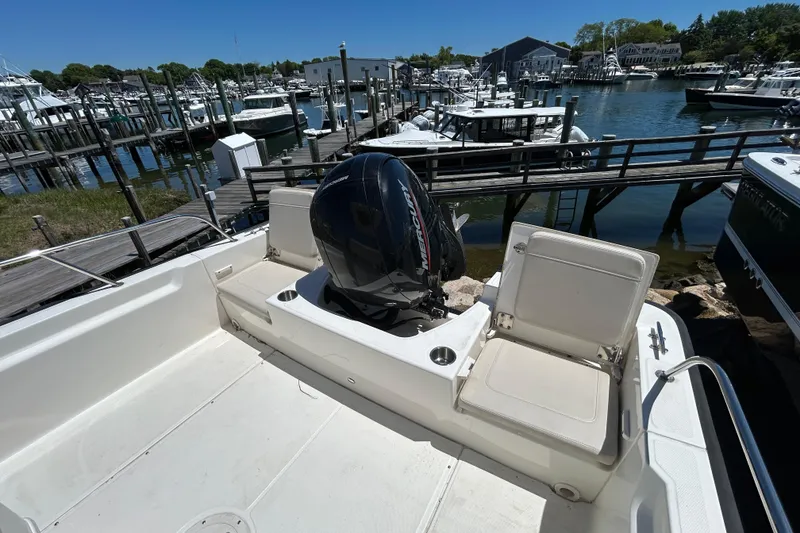 Slide: The Image of 2021 Boston Whaler 210 Montauk boat docked at a marina with Mercury outboard engine. - 6