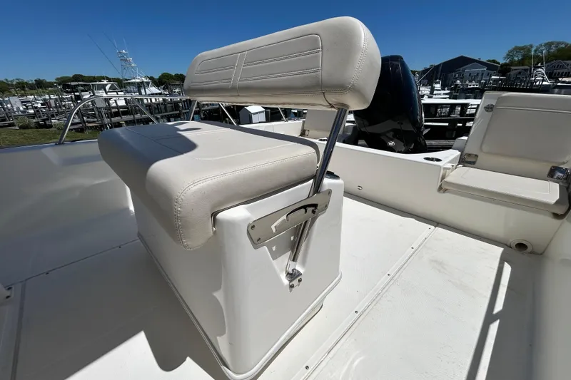 Slide: The Image of 2021 Boston Whaler 210 Montauk boat interior with cushioned seating and sleek design. - 8