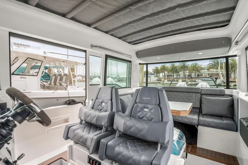 Slide: The Image of Interior of 2021 Axopar 37 XC Cross Cabin with luxurious seating and panoramic windows. - 14