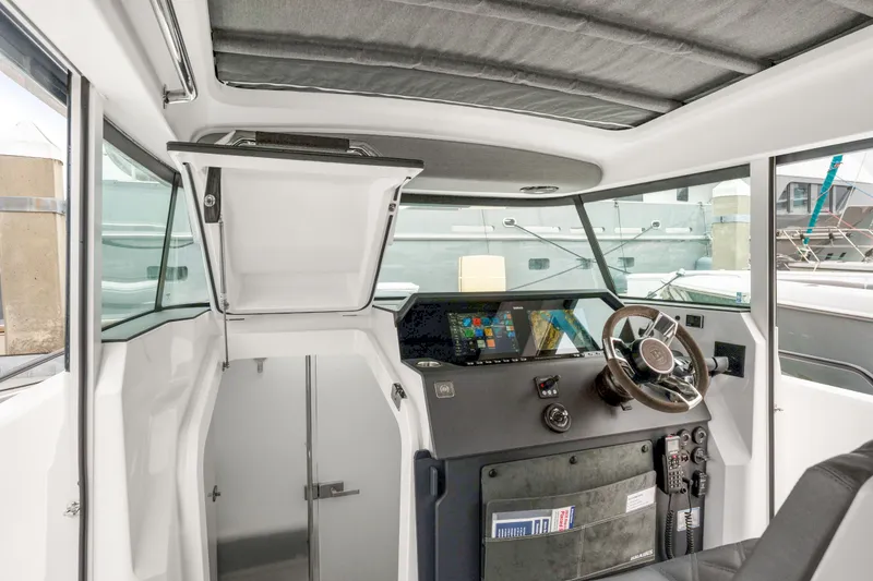 Slide: The Image of 2021 Axopar 37 XC Cross Cabin interior with modern helm and navigation system. - 15
