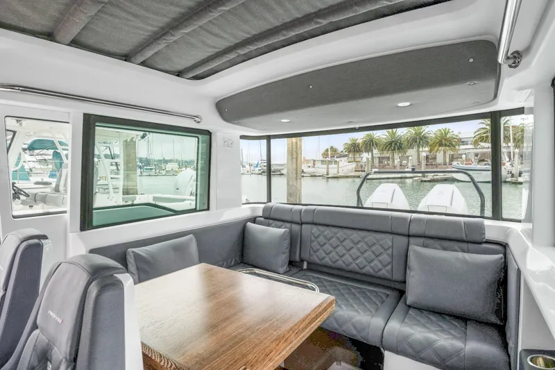 Slide: The Image of Luxurious interior of 2021 Axopar 37 XC Cross Cabin with plush seating and waterfront view. - 16