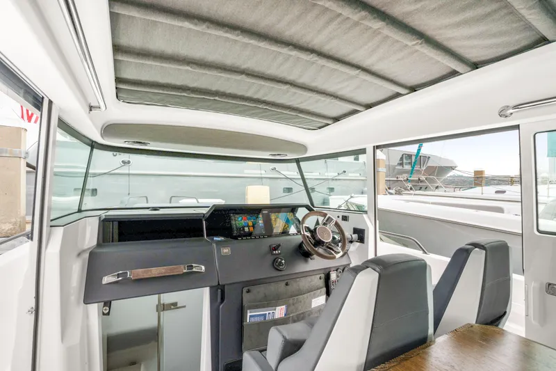Slide: The Image of Interior of 2021 Axopar 37 XC Cross Cabin with modern helm and seating. - 17