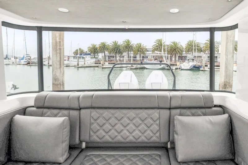 Slide: The Image of Interior view of 2021 Axopar 37 XC Cross Cabin with marina backdrop. - 19