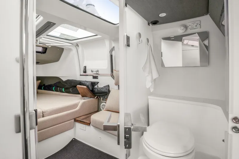 Slide: The Image of 2021 Axopar 37 XC Cross Cabin interior with bed and compact bathroom. - 21