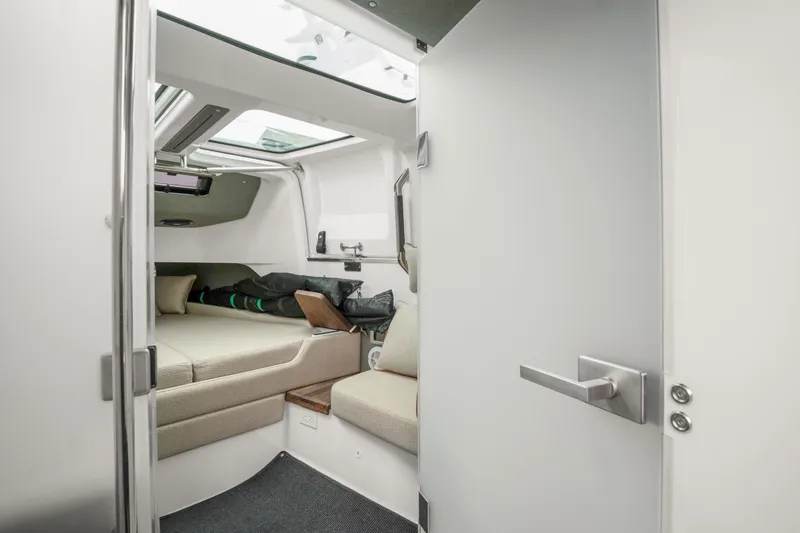 Slide: The Image of Interior cabin of 2021 Axopar 37 XC Cross Cabin, featuring cozy seating and modern design. - 22