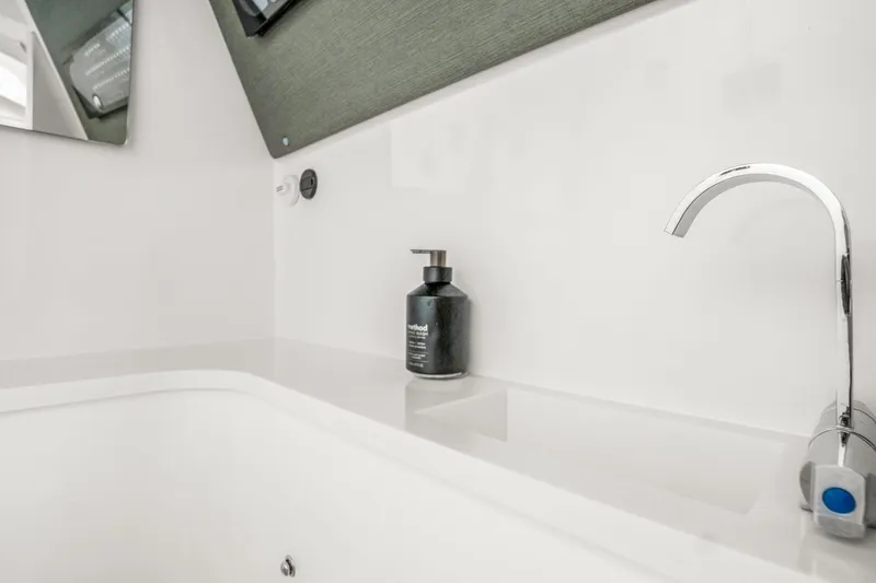 Slide: The Image of Modern bathroom sink with chrome faucet in 2021 Axopar 37 XC Cross Cabin. - 25