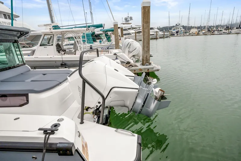 Slide: The Image of Axopar 37 XC Cross Cabin 2021 docked with outboard engines in a marina. - 27