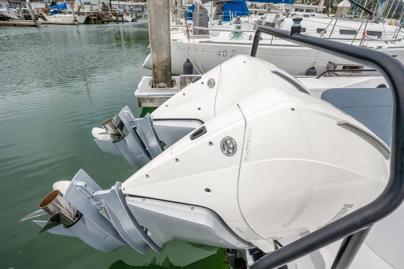 Slide: The Image of Twin outboard engines on a 2021 Axopar 37 XC Cross Cabin at a marina. - 29