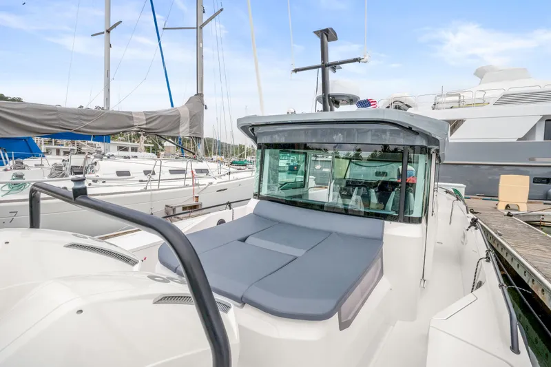 Slide: The Image of 2021 Axopar 37 XC Cross Cabin docked at a marina, surrounded by sailboats. - 30