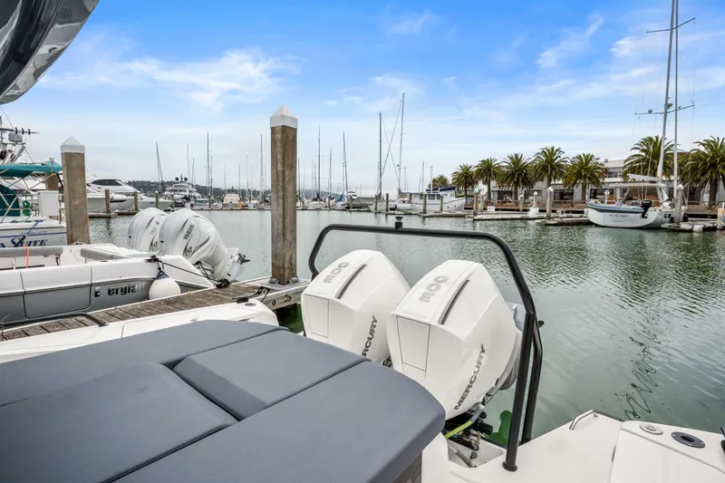 Slide: The Image of 2021 Axopar 37 XC Cross Cabin docked at a marina with palm trees. - 31