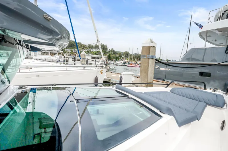 Slide: The Image of 2021 Axopar 37 XC Cross Cabin docked at a marina, showcasing sleek design and comfort. - 32