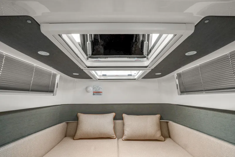 Slide: The Image of 2021 Axopar 37 XC Cross Cabin interior with skylight and cozy seating area. - 35